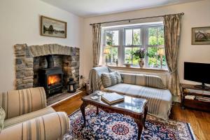 a living room with a couch and a fireplace at 2 Bed in Blackmill oc-c29623 in Brynmenin