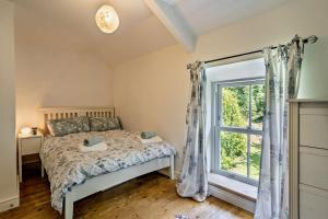 a bedroom with a bed and a window at 2 Bed in Blackmill oc-c29623 in Brynmenin