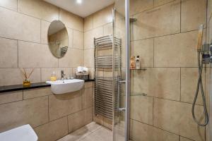 a bathroom with a shower and a sink and a mirror at 2 Bed in Blackmill oc-c29623 in Brynmenin +25 photos
