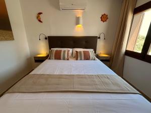 a bedroom with a large bed with two pillows at ArteVida Andalusia FKK Nudist Holiday with yoga and massage in Mojácar