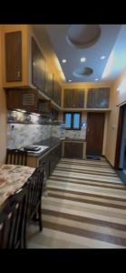 a large kitchen with a table and counters and cabinets at Unique Stays in Pondicherry
