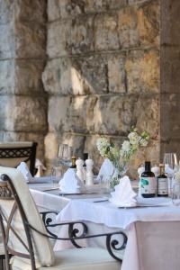 a table with white table cloths and flowers on it at Amadria Park Hotel Sveti Jakov in Opatija