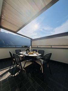 a dining room with a table and chairs on a balcony at Buddy'S House Lake view Dog friendly whit garage in Abbadia Lariana