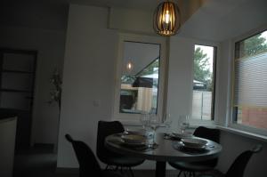 a dining room with a table with wine glasses on it at Vakantiewoning Duinviooltje-Koksijde in Koksijde
