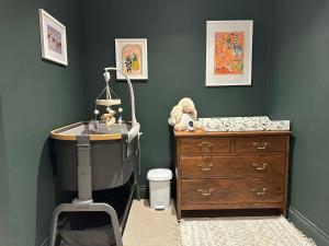 a bedroom with a bed and a dresser and a sink at Riverview House in Minnigaff +46 photos