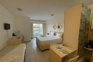 a hotel room with a bed and a television at Flat no Terrazzo perto do mar in Natal +72 photos