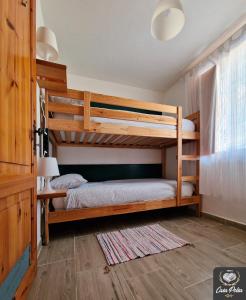 a bedroom with two bunk beds in a house at Casa Polsa 1964 in Brentonico