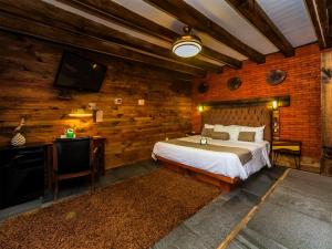 a bedroom with a bed and a flat screen tv at Hotel Casa Anzures in Mexico City