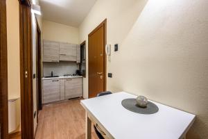 a small kitchen with a white table in a room at Emilia Studios 2 in Modena