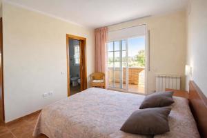 a bedroom with a bed and a large window at Catalunya Casas Tranquil Costa Brava Retreat with private suite! in Sils +24 photos