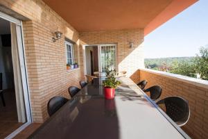 a table and chairs on the balcony of a house at Catalunya Casas Tranquil Costa Brava Retreat with private suite! in Sils