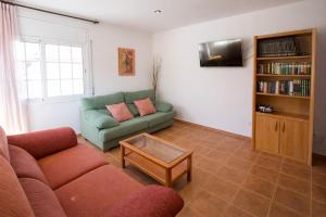 a living room with a couch and a book shelf at Catalunya Casas Tranquil Costa Brava Retreat with private suite! in Sils