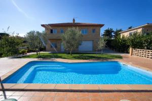 a villa with a swimming pool in front of a house at Catalunya Casas Tranquil Costa Brava Retreat with private suite! in Sils