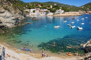 a group of people on a beach in the water at Catalunya Casas Tranquil Costa Brava Retreat with private suite! in Sils