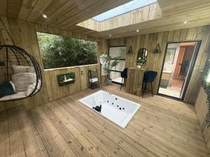 a large room with a tub in the middle of a house at Willow Lodge in Ringwood