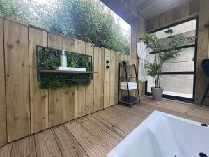 a room with a wooden wall with a sink on it at Willow Lodge in Ringwood