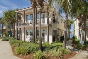 a building with palm trees in front of it at Destiny Beach Villas #9A in Destin