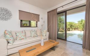 a living room with a couch and a table at Neema Villa with Private Pool in Zakynthos