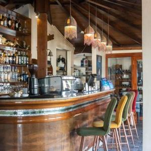 a bar with chairs and a counter in a restaurant at DreamCatcher Paragliders in Tamelalt