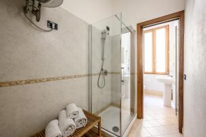 a bathroom with a shower and a glass shower stall at Emilia Studios 3 in Modena
