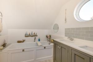 a bathroom with two sinks and a large tub at 5 Bed in Bosham oc-h33962 in Bosham +39 photos