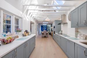 a kitchen with gray cabinets and a white ceiling at 5 Bed in Bosham oc-h33962 in Bosham
