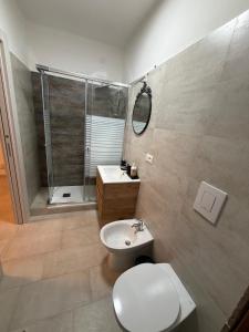 a bathroom with a toilet and a sink and a shower at Il Covo dell'aquila in LʼAquila