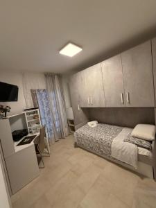 a bedroom with a bed and a desk and a television at Il Covo dell'aquila in LʼAquila