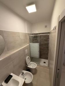 a bathroom with a toilet and a sink at Il Covo dell'aquila in LʼAquila