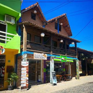 a store with signs in front of a building at Cacau Biruta in Itacaré