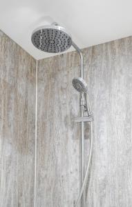 a shower with a shower head in a bathroom at Apt 2 Armatage Flats, Eyemouth in Eyemouth