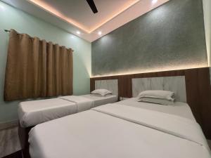 two twin beds in a room with at HOTEL SREE DURGA in Kolkata