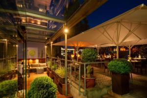 an outdoor restaurant with tables and umbrellas at night at Bachofer in Waiblingen