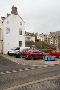 a group of cars parked in a parking lot at Apt 2 Armatage Flats, Eyemouth in Eyemouth