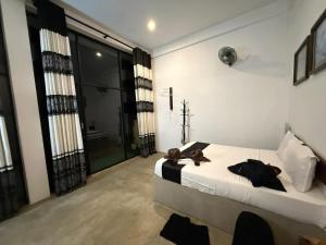 a bedroom with a bed with a teddy bear on it at Ridge Boundary View in Dambulla