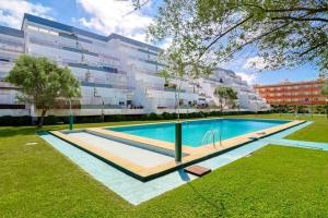 a swimming pool in front of a large building at Refugio do Atlântico in Marinhas