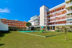 a playground in front of a apartment building at Refugio do Atlântico in Marinhas