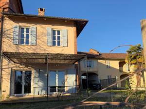 an old house with a fence in front of it at La Trifola in Scurzolengo