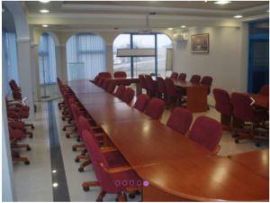 a conference room with a long table and red chairs at Hotel Split in Usora
