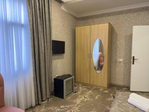 a room with a mirror and a tv in it at Aquapark Quba Hotel in Quba +9 photos