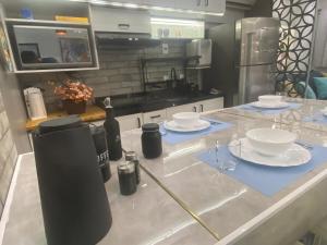 a kitchen counter with plates and wine glasses on it at Studio Arte de Cuidar in Campinas +26 photos