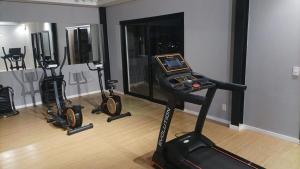 a gym with three exercise bikes in a room at Studio Arte de Cuidar in Campinas