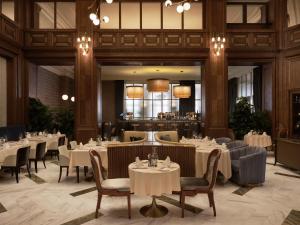 a restaurant with tables and chairs and a bar at Hotel Capital in Zagreb