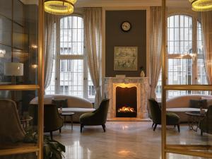 a living room with a fireplace and a fire place at Hotel Capital in Zagreb