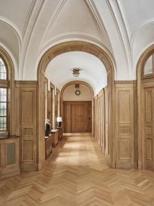 an ornate hallway with wood paneling and a ceiling at Hotel Capital in Zagreb