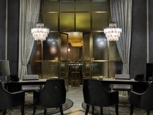 a dining room with two tables and chairs and chandeliers at Hotel Capital in Zagreb +89 photos
