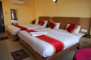 two beds in a hotel room with two bedsvisor at Hotel Ganga Sagar in Kathmandu