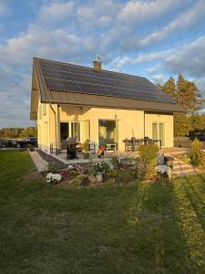 a house with solar panels on top of it at Gościniec Wigry 2 in Walne