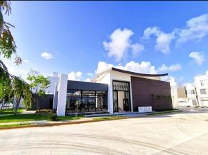 a large white building with a lot of windows at Casa de lujo en Playa del Carmen in Playa del Carmen