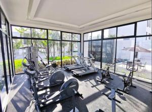 a gym with several tread machines in a room with windows at Casa de lujo en Playa del Carmen in Playa del Carmen